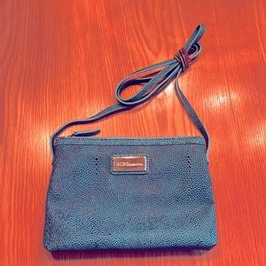 Like new, BCBG Generation faux leather cross body.  Teal in color.